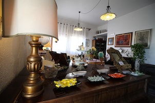 A dining area with a wooden table set with various dishes and a decorative lamp.