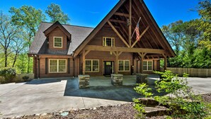 A large, two-story log cabin with a prominent gable roof and an American flag. - Trenton Cabin w/ Hot Tub - 14 Mi to Lookout Mtn! (Trenton)