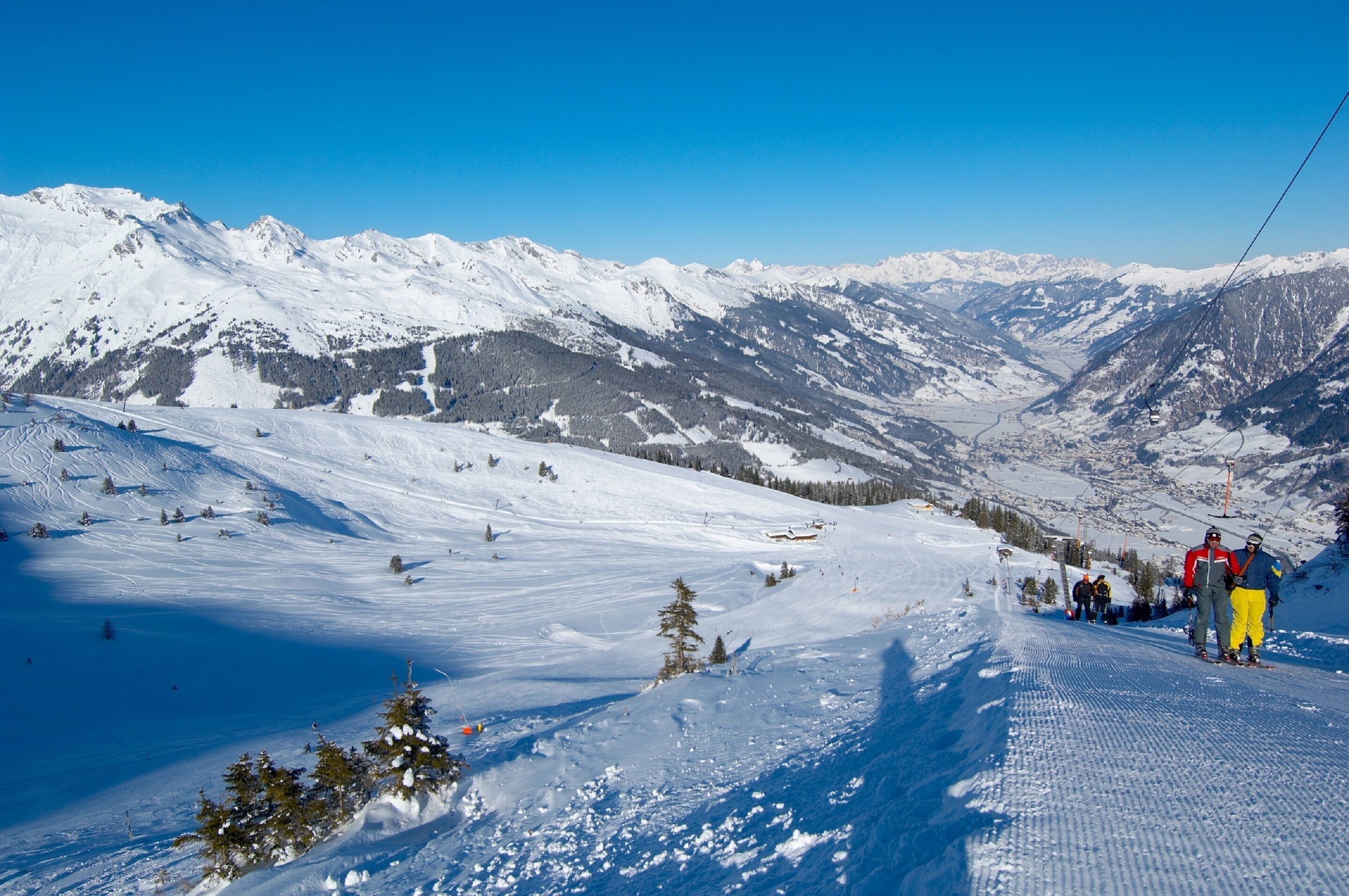 A snowy mountain landscape with ski slopes and a ski lift.