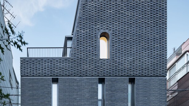 A modern building with a flat roof, a central entrance, and a sign reading "DW STAY". - DW Stay Hongdae (Seoul)