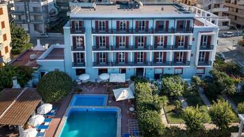 Seasonal outdoor pool, open 11:00 AM to 7:00 PM, pool umbrellas