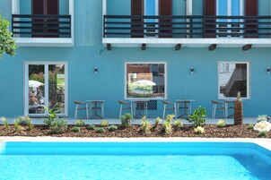 Seasonal outdoor pool, open 11:00 AM to 7:00 PM, pool umbrellas