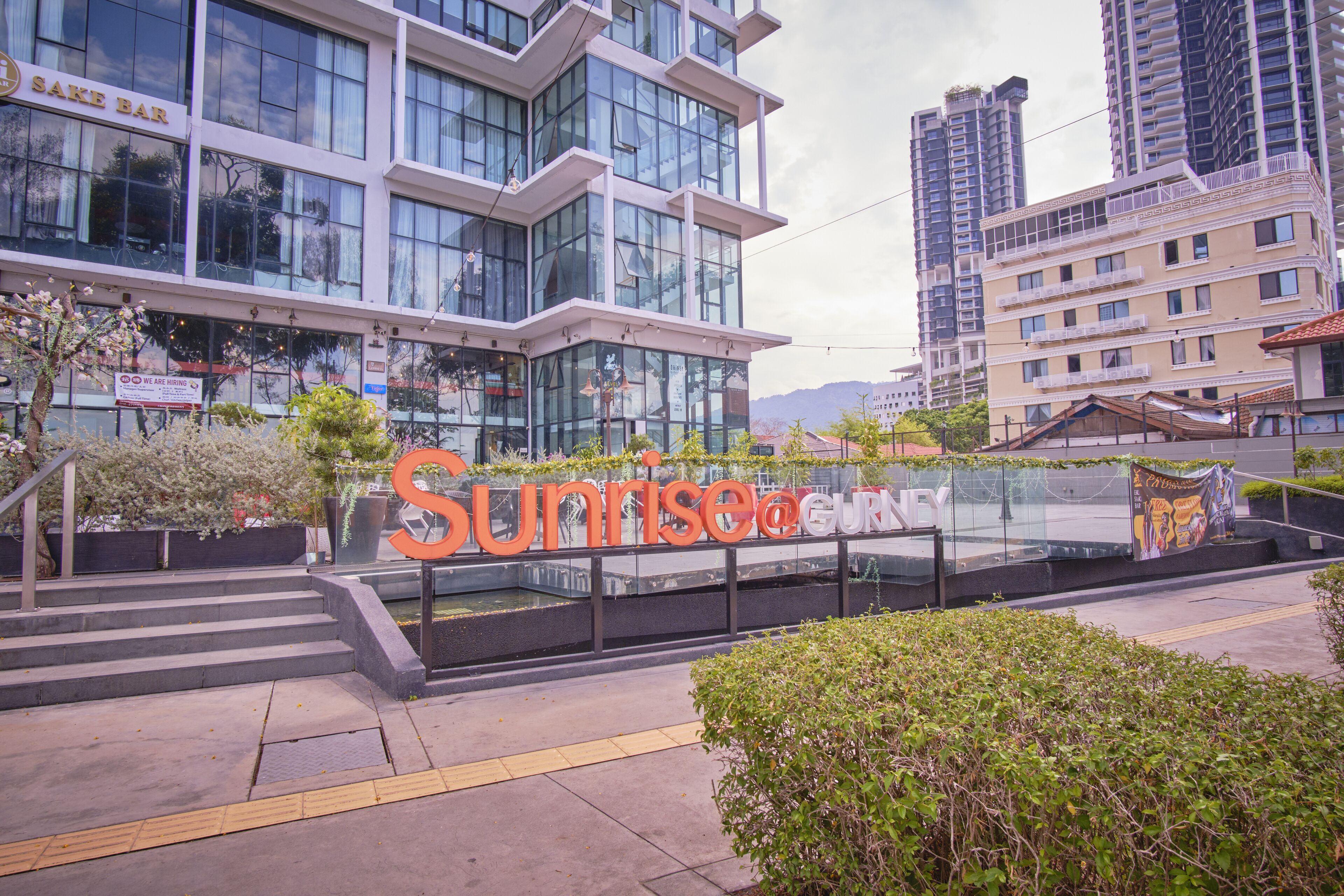 A modern building with a large sign reading "Sunrise@EUR".