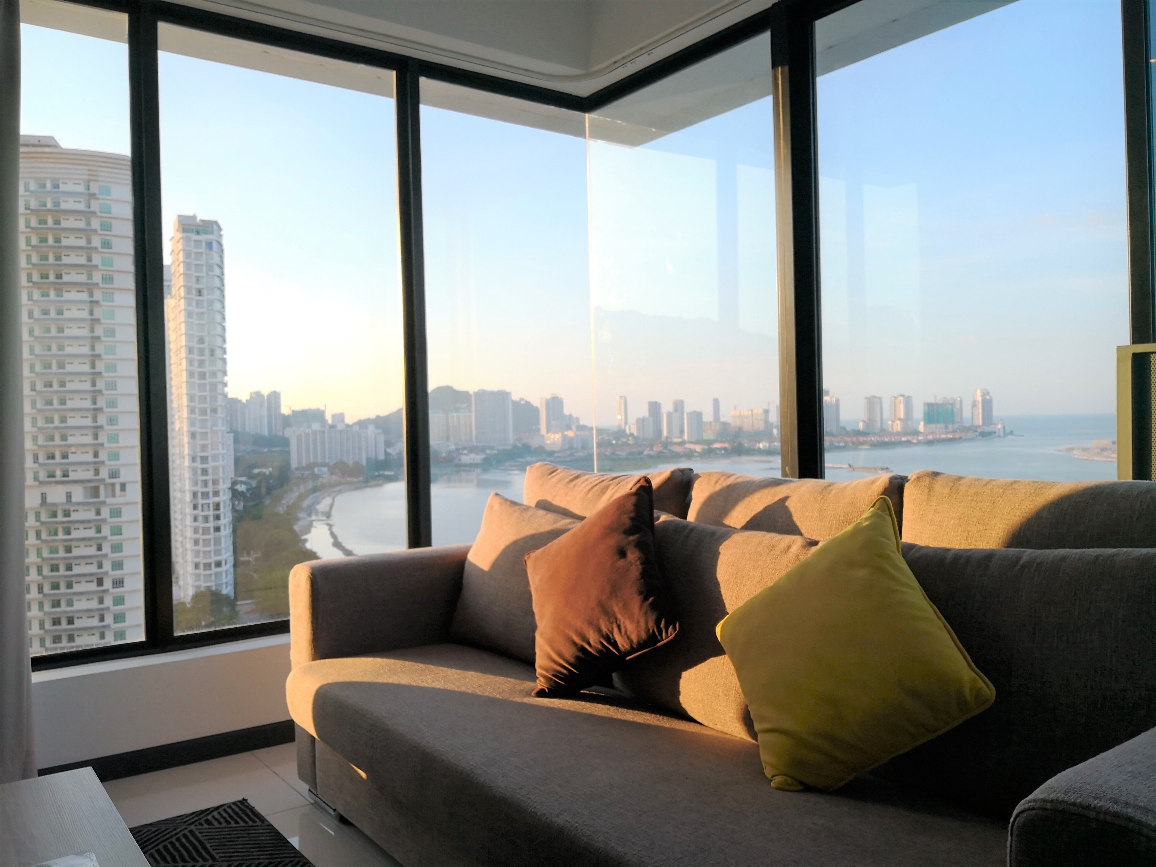A modern living room with a large window offering a city view.