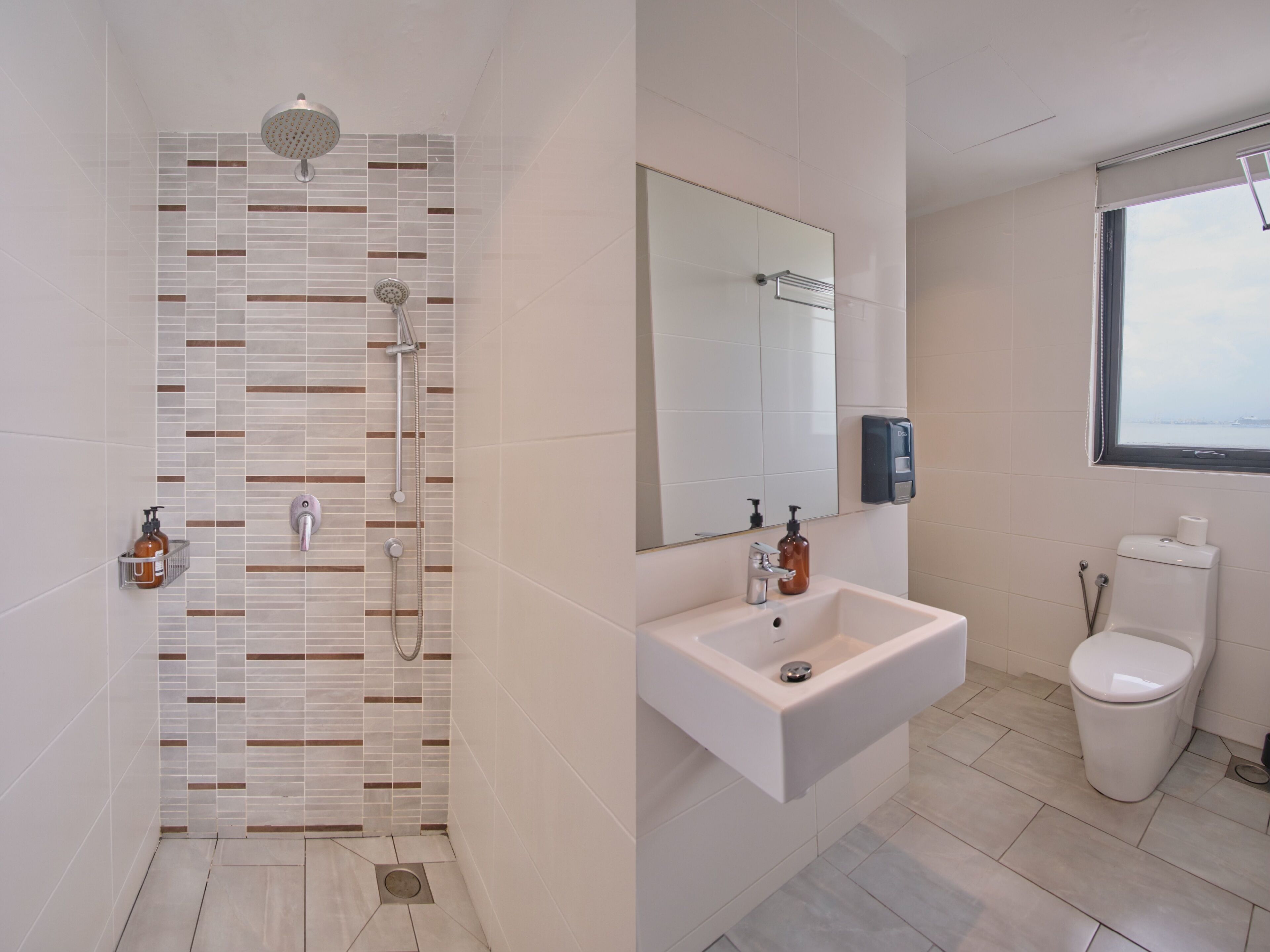 Un baño moderno con ducha, lavabo, inodoro y un espejo grande.