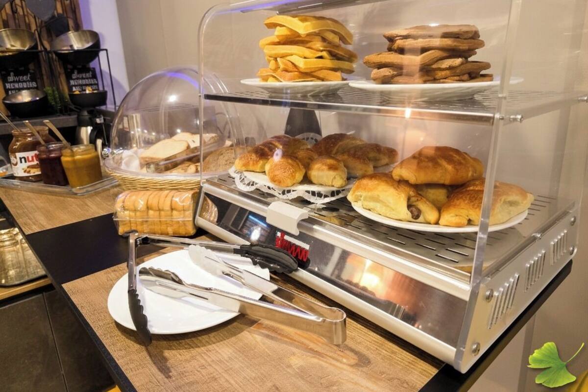 A bakery display case with pastries and bread.