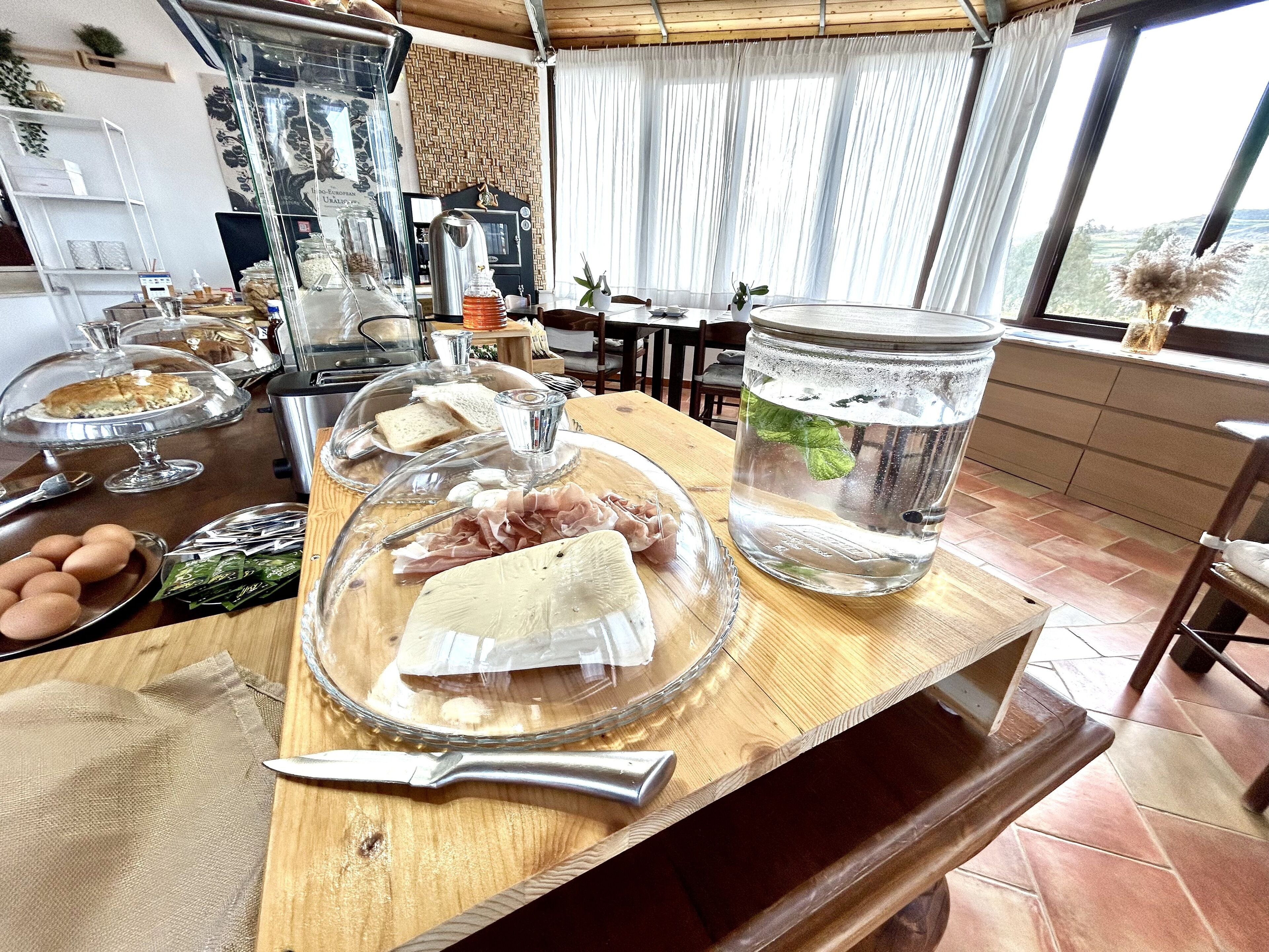 A kitchen counter with food items, a knife, and a water container.