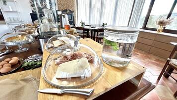 A kitchen counter with food items, a knife, and a water container.