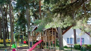 A playground with a slide, swings, and a climbing structure.