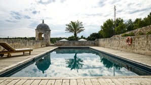 A swimming pool with a wooden deck, a lifebuoy, and a palm tree. -  Santa Ponsa - Fontenille Collection (Alayor)