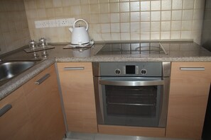 Apartment, City View | Private kitchen | Fridge, microwave, oven, stovetop - By The Sea I (Limassol)