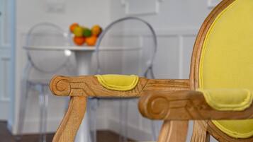 A wooden chair with a yellow cushion and a round backrest.