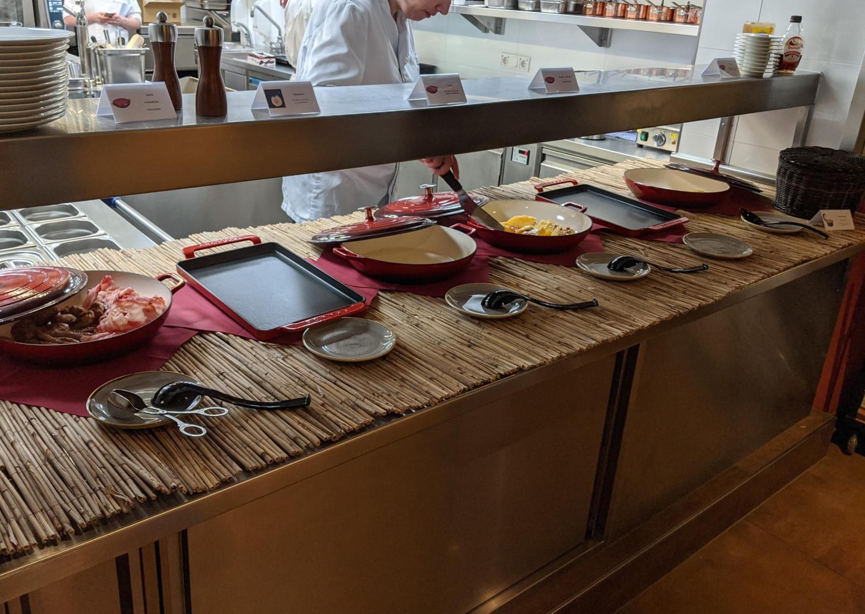 Disposição de buffet com diversos pratos e utensílios.
