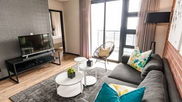 Executive Two Bedroom Apartment | Living area | Flat-screen TV