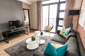 Executive Two Bedroom Apartment | Living area | Flat-screen TV