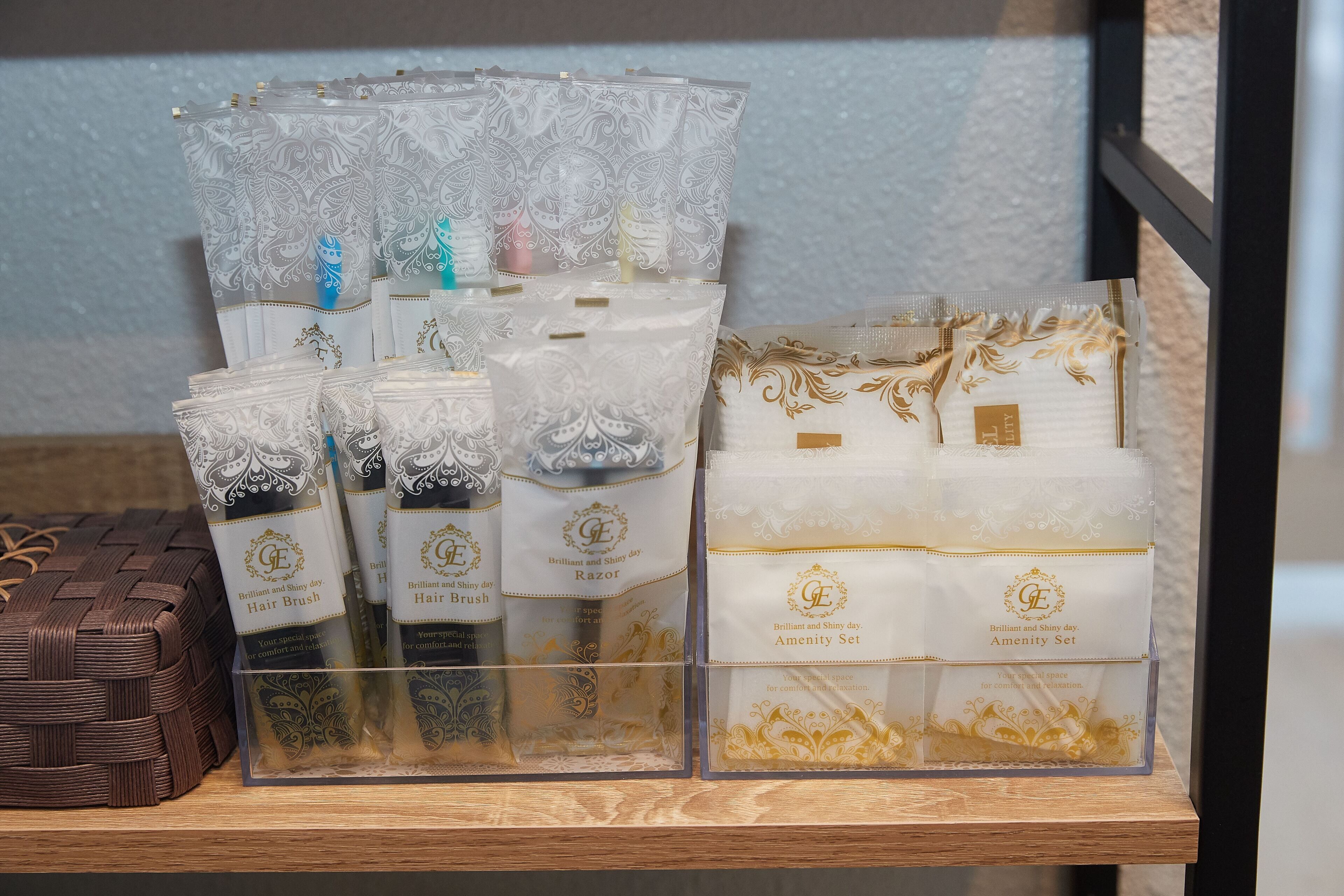 A display of hair care products in transparent containers with gold and white designs.