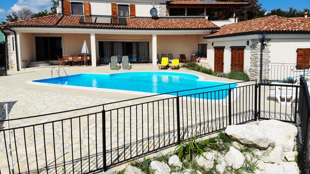 A two-story house with a swimming pool, stone patio, and a fenced area. - Arton Villa in the Heart of Istria (Zminj)