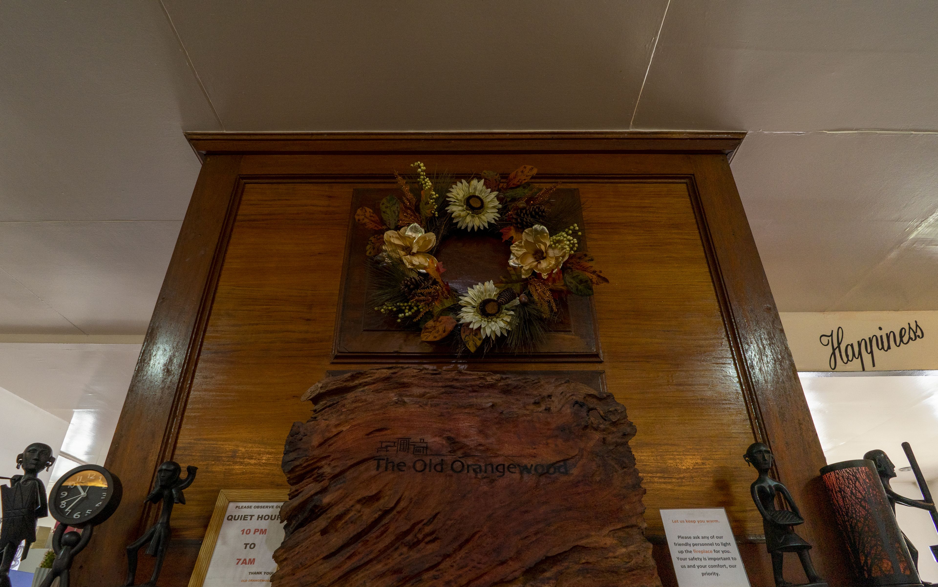 A wooden display with a decorative wreath and a plaque reading "The Old Orangewood."