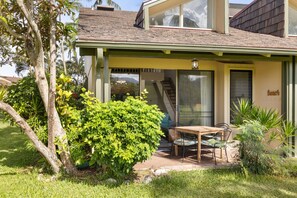 A house with a covered patio, a dining table, and chairs.