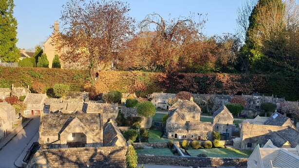 A model village with stone buildings, a small road, and a grassy area. - The Old New Inn (Cheltenham)