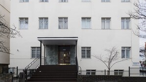 A multi-story building with a central entrance, a staircase, and a sign indicating 'Westbourne Gardens W2'. - Westbourne Gardens by Lime Street (London)
