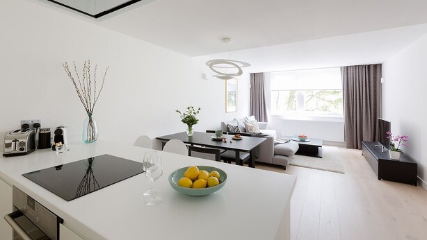 A modern kitchen with a dining area, a living room, and a TV. - Craven Hill by Lime Street (London)