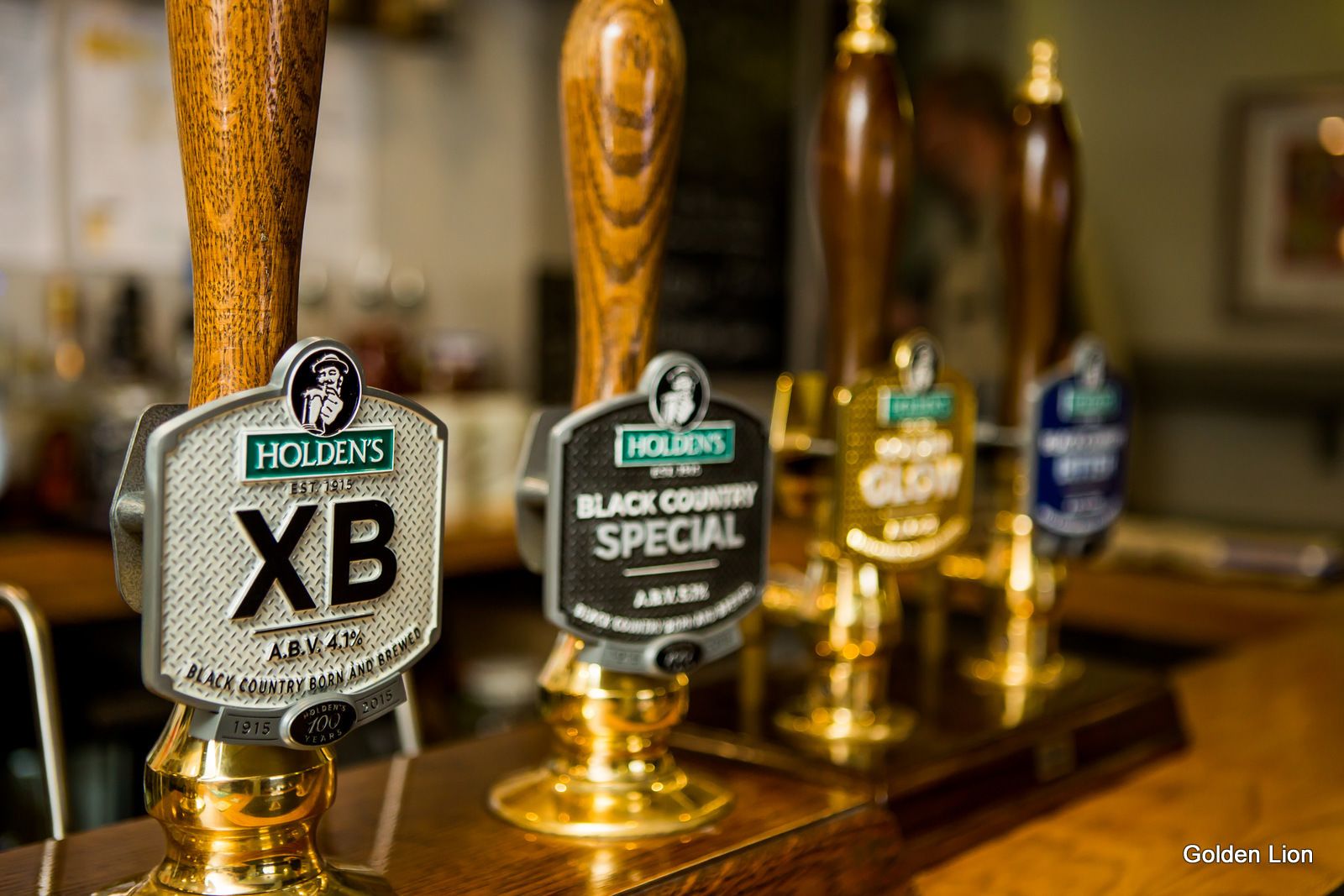 A bar with various beer taps, including a 'Holden's XB' and a 'Black Country Special'.