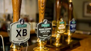 A bar with various beer taps, including a 'Holden's XB' and a 'Black Country Special'.