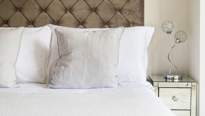 A neatly made bed with white linens and a tufted headboard. - Star Street by Lime Street (London)