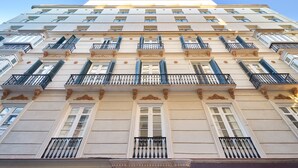 Un edificio a più piani con balconi, ampie finestre e dettagli architettonici classici.