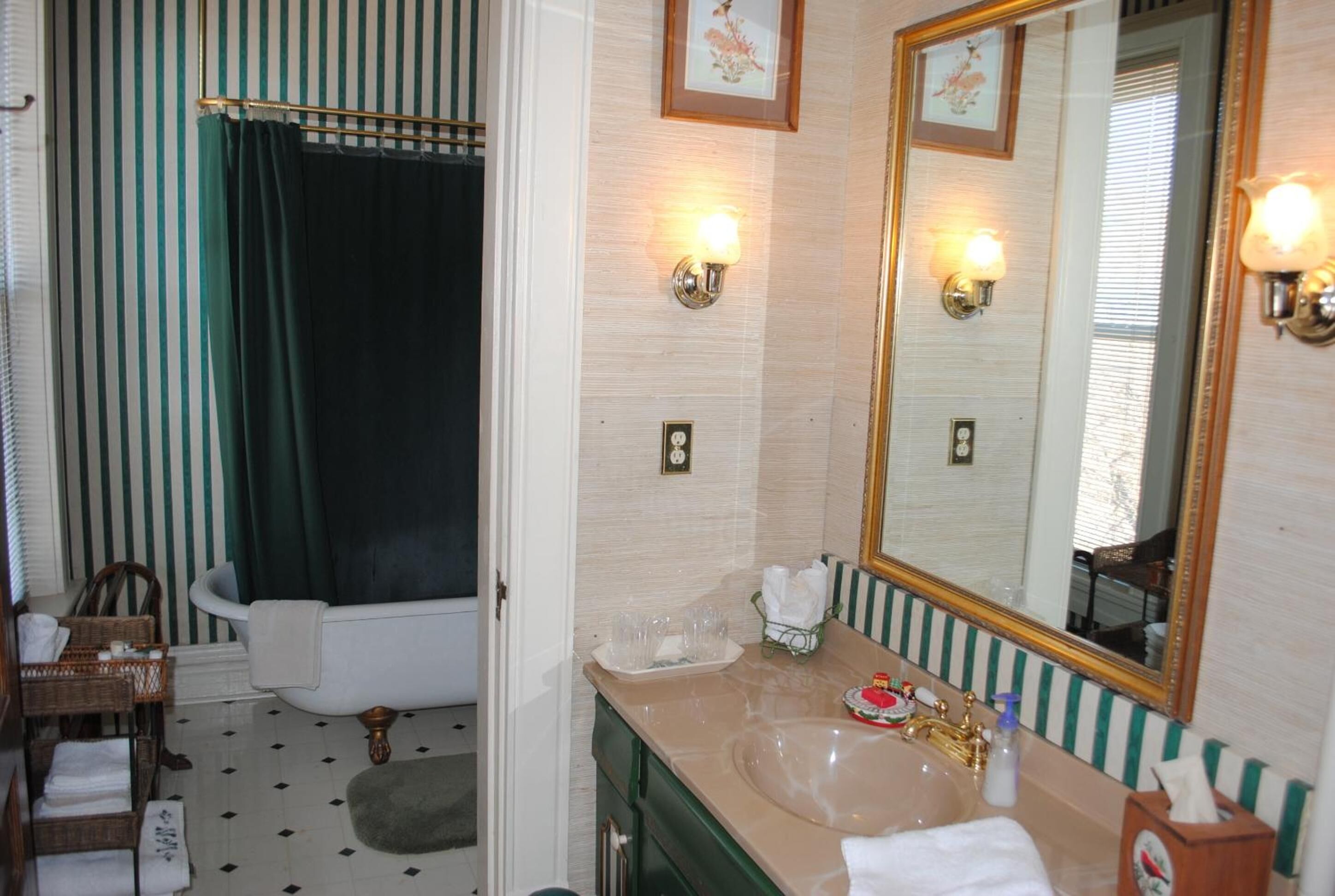 A bathroom with a bathtub, a sink, and a mirror.