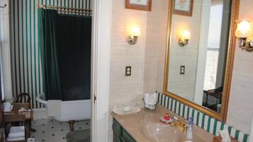 A bathroom with a bathtub, a sink, and a mirror.