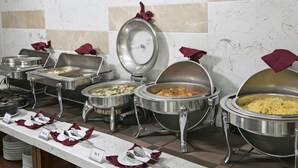 A buffet setup with multiple serving stations, each with a covered dish and a spoon. - Phuc Thanh Hotel (Da Nang)