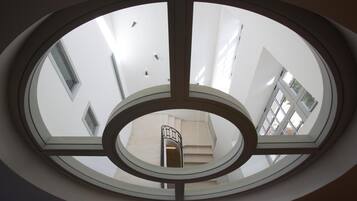 A circular skylight with a central elevator shaft.