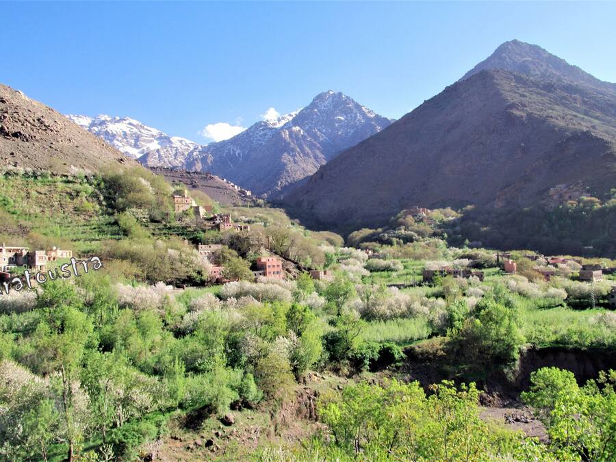 A mountainous landscape with scattered buildings, likely a rural or remote area.
