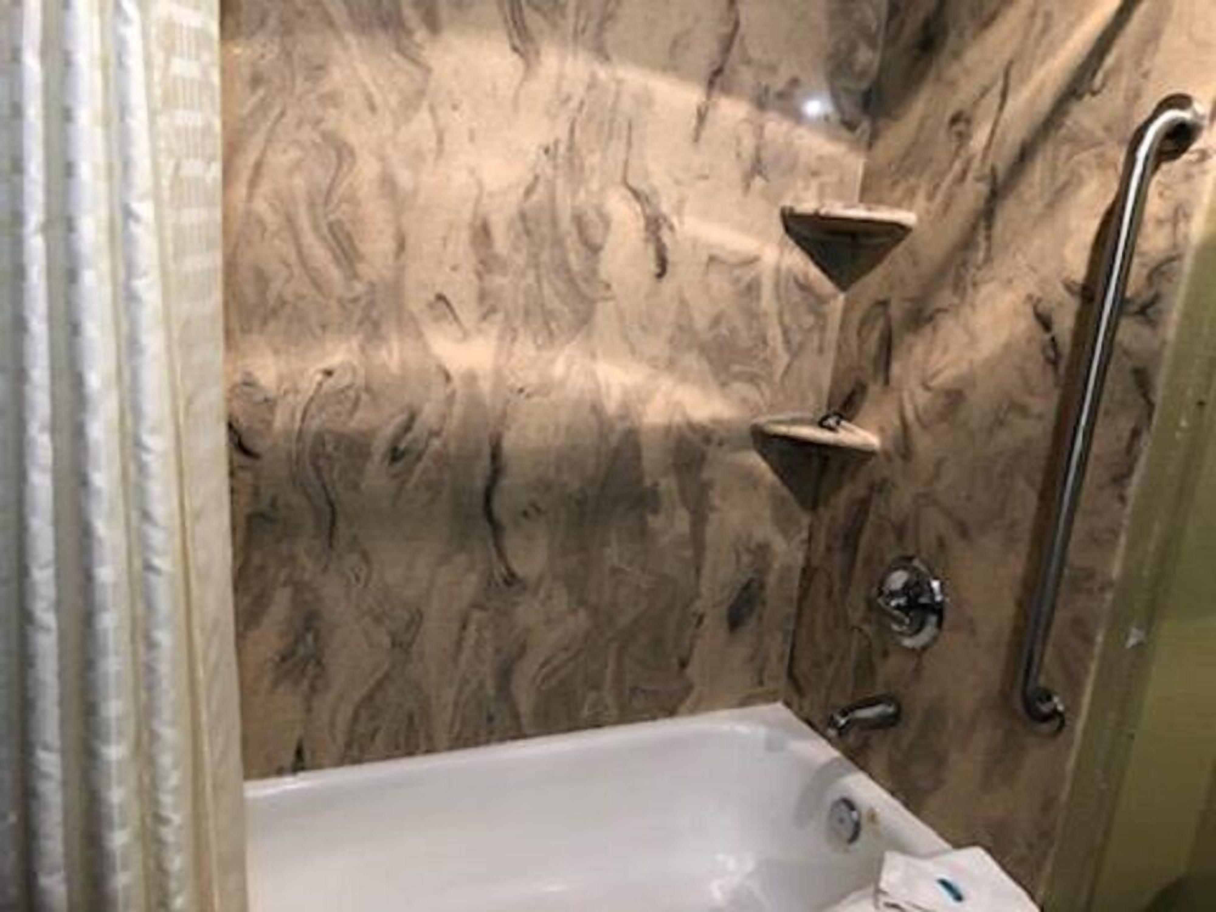 economy single room, 1 king bed | bathroom | combined shower/bathtub, designer toiletries, hair dryer, towels