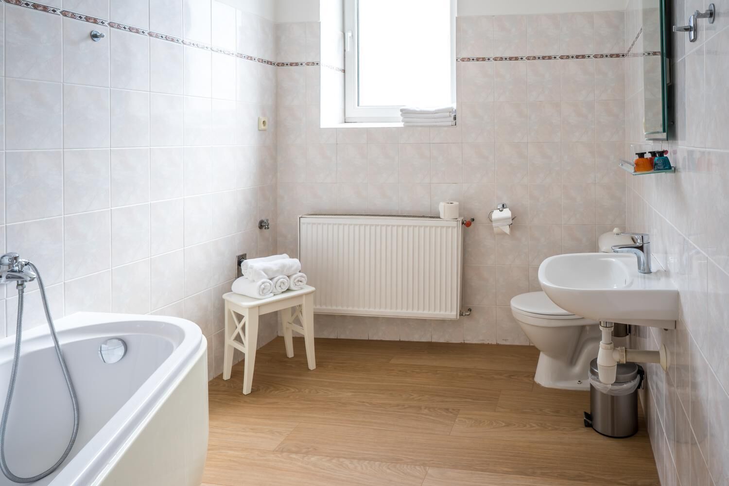 A bathroom with a bathtub, toilet, and sink.