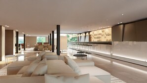 Un moderno hall de hotel con zona de estar, un bar y vistas al exterior.