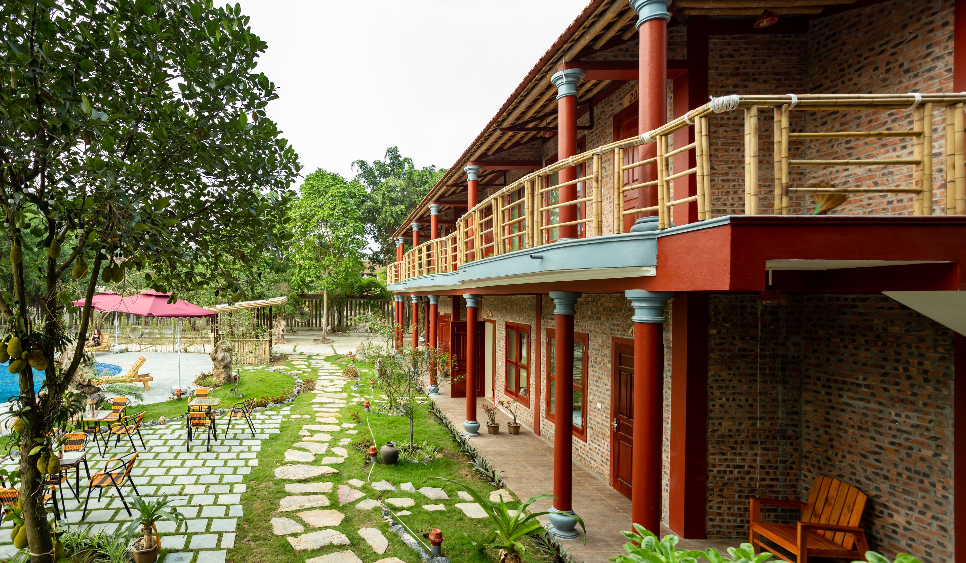 A courtyard with a pool, outdoor seating, and a covered walkway.