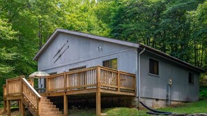A cabin with a wooden deck, a staircase, and a small porch. - White Deer (Davis)