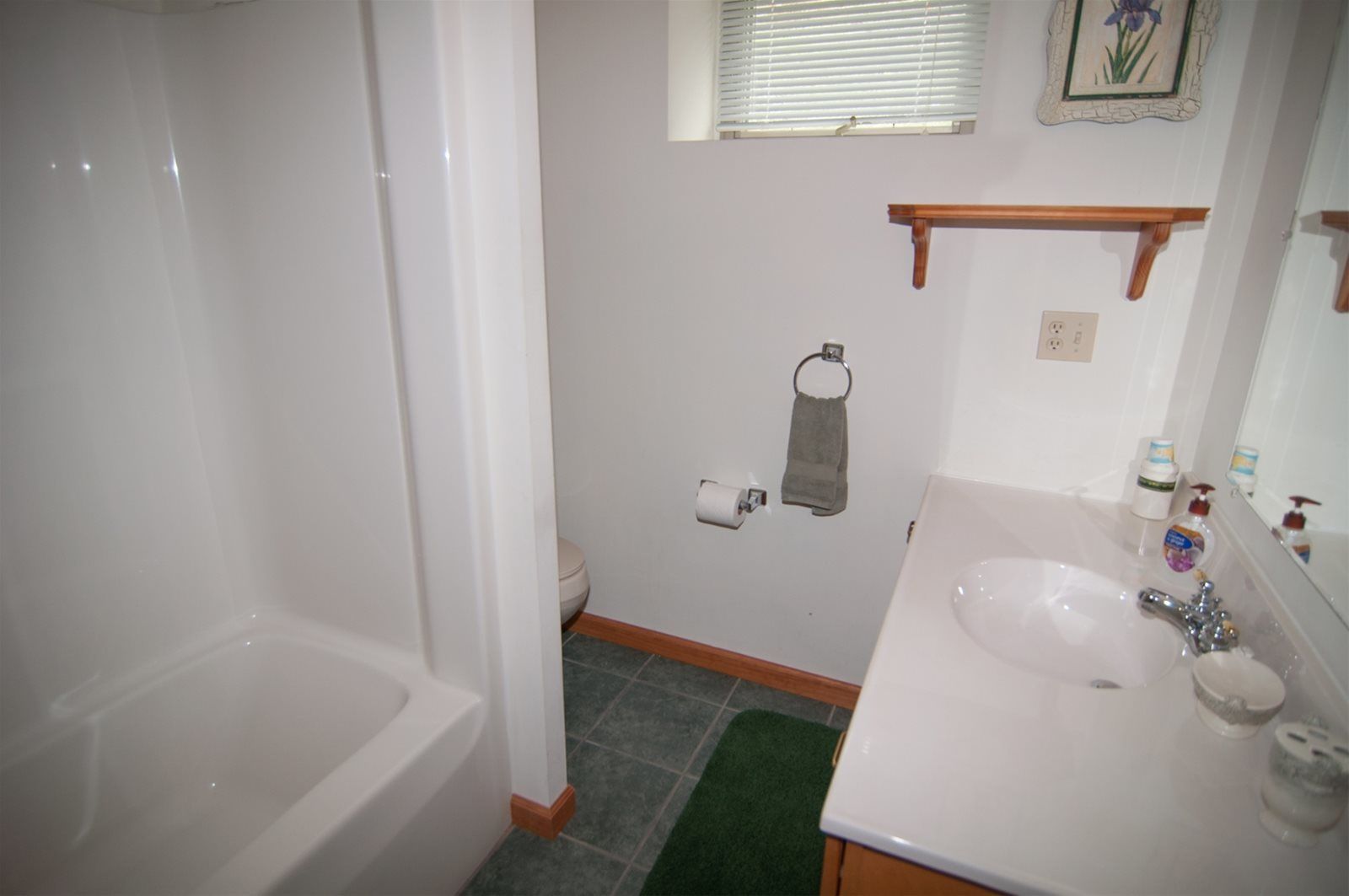 A bathroom with a bathtub, toilet, and sink.