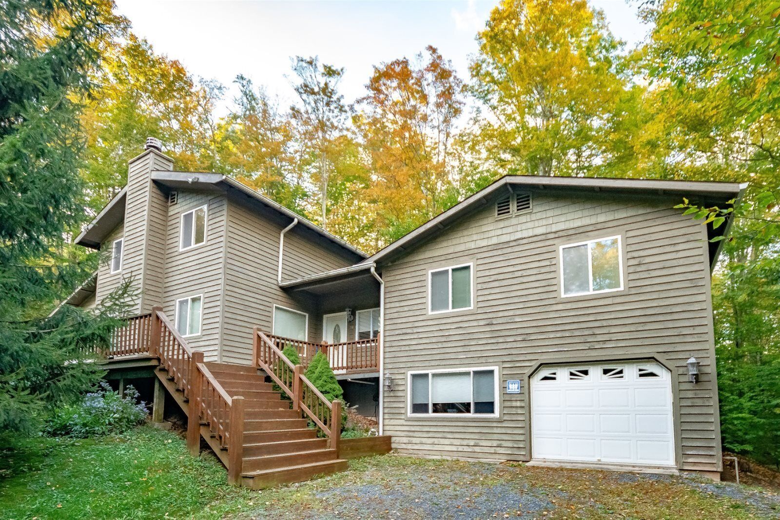 A two-story house with a front porch, a staircase, and a garage.