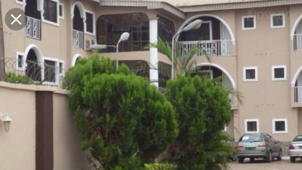 A multi-story building with balconies and a parking area. - Meridian Lodge hotels & resorts (Benin City)