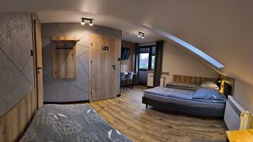A modern bedroom with a loft bed, a wooden wardrobe, a desk, and a view of the outdoors.