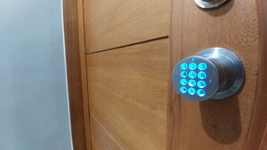 A door with a modern, circular keypad lock.