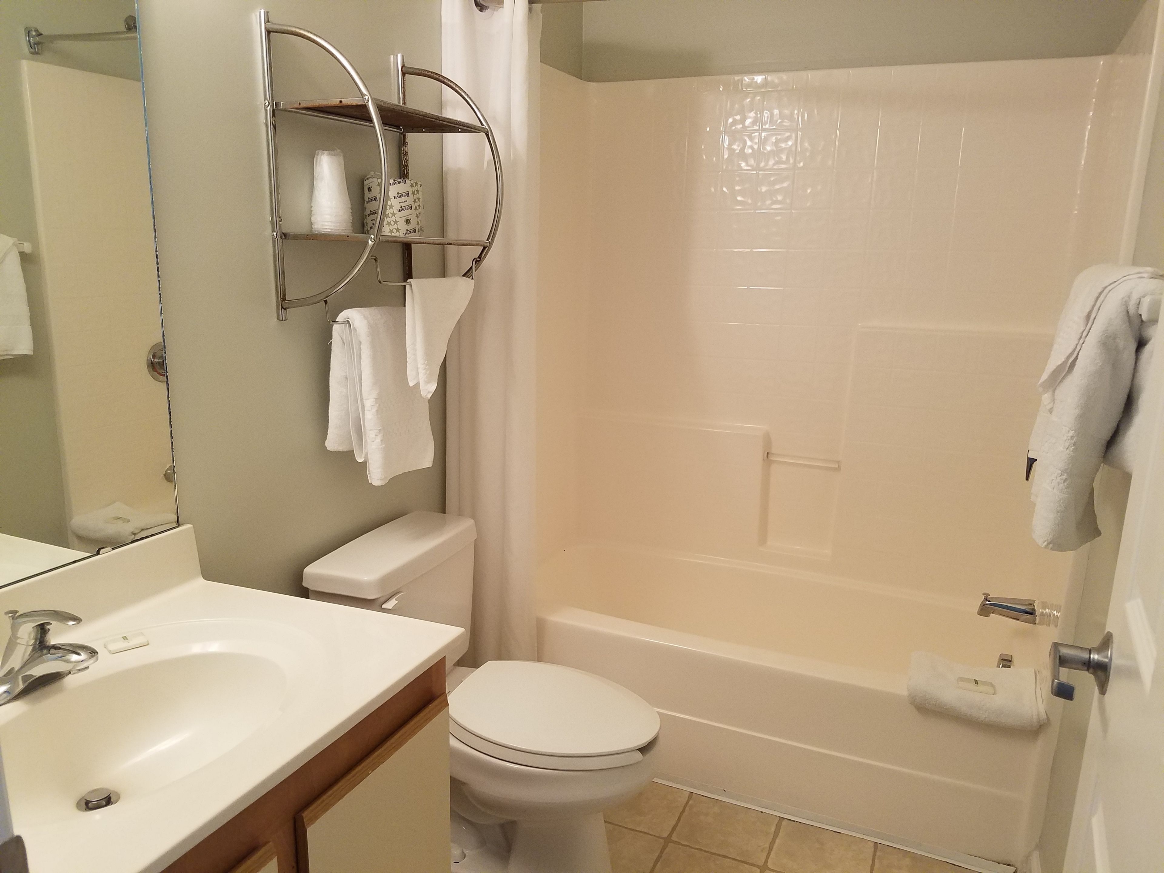 A bathroom with a sink, toilet, and bathtub.