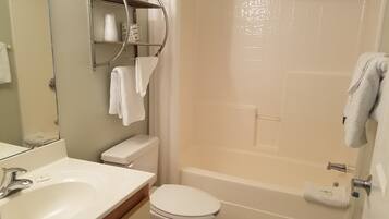 A bathroom with a sink, toilet, and bathtub.