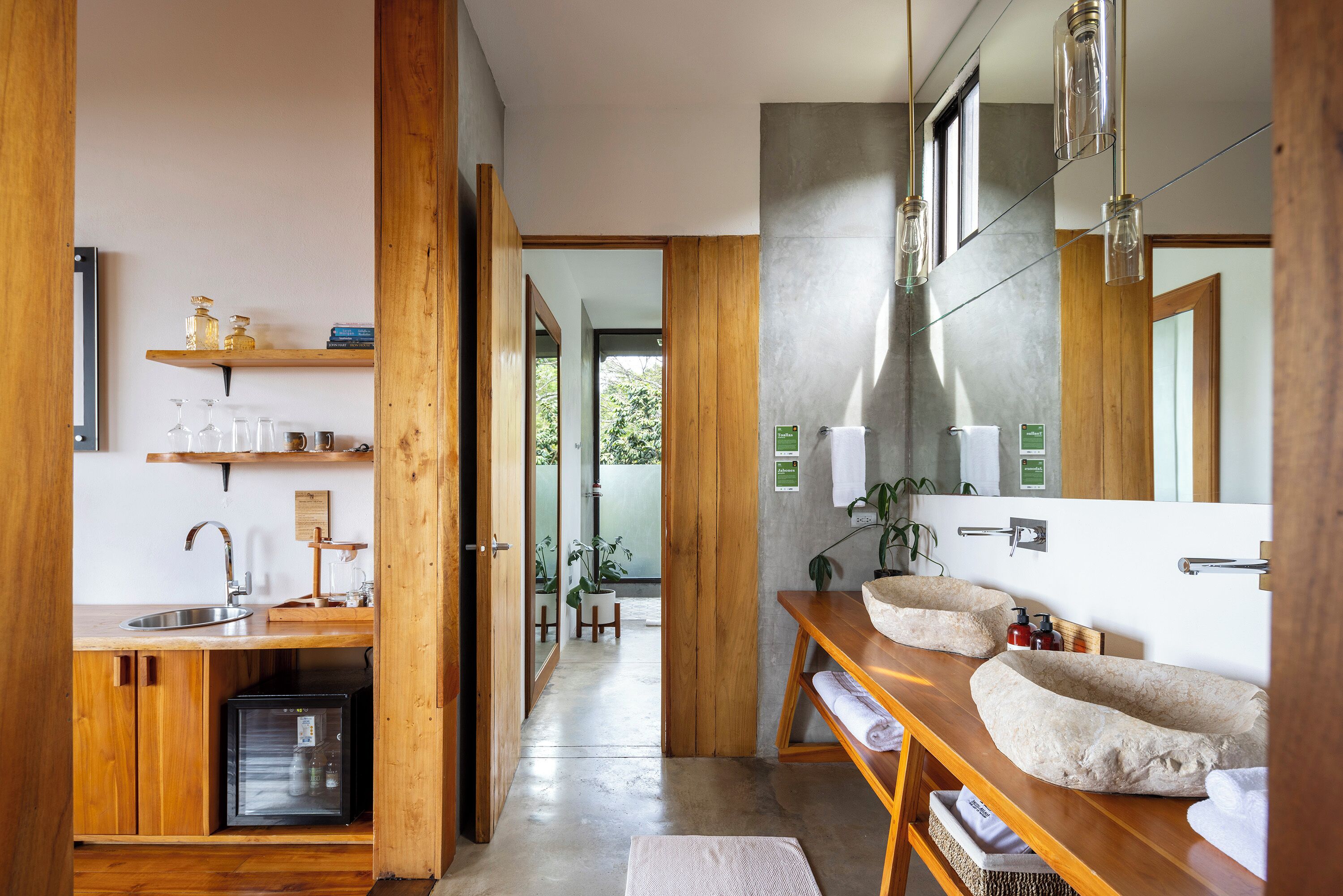 A modern bathroom with wooden cabinetry, a built-in sink, and a large mirror.
