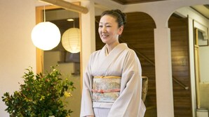 A traditional Japanese interior with wooden beams, a hanging light fixture, and a potted plant. - Takezono Ryokan (Shimonoseki)