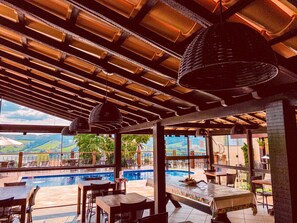 Una piscina al aire libre, sillones reclinables de piscina